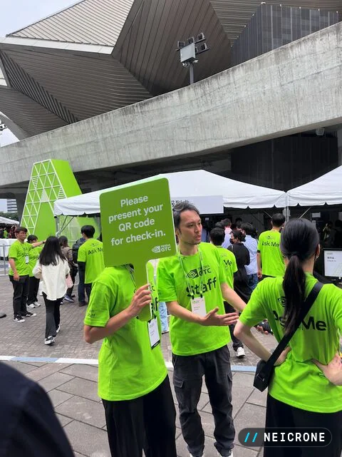 GTC staff in green shirts directing attendees to QR-code check-in