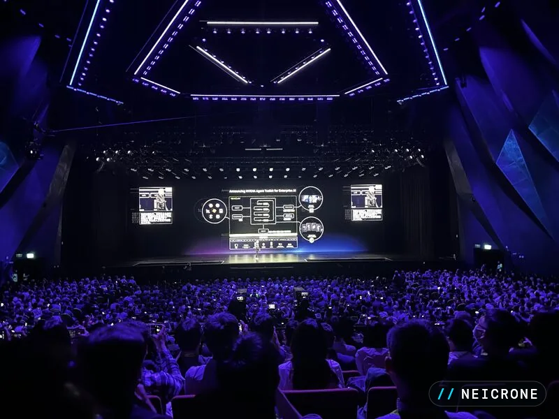 Wide view of the keynote hall lit in blue and purple