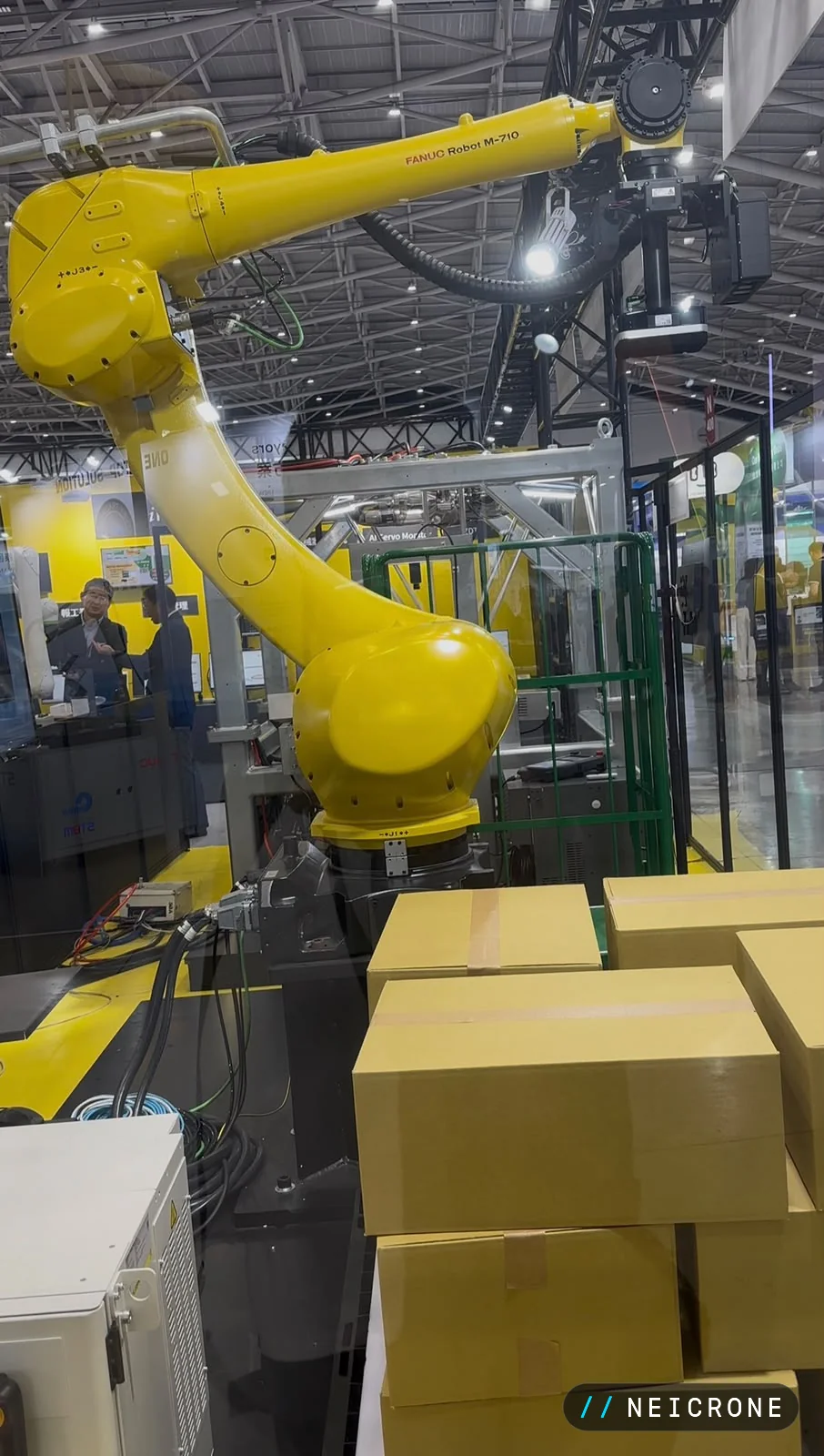 Large industrial robot arm palletising cardboard boxes